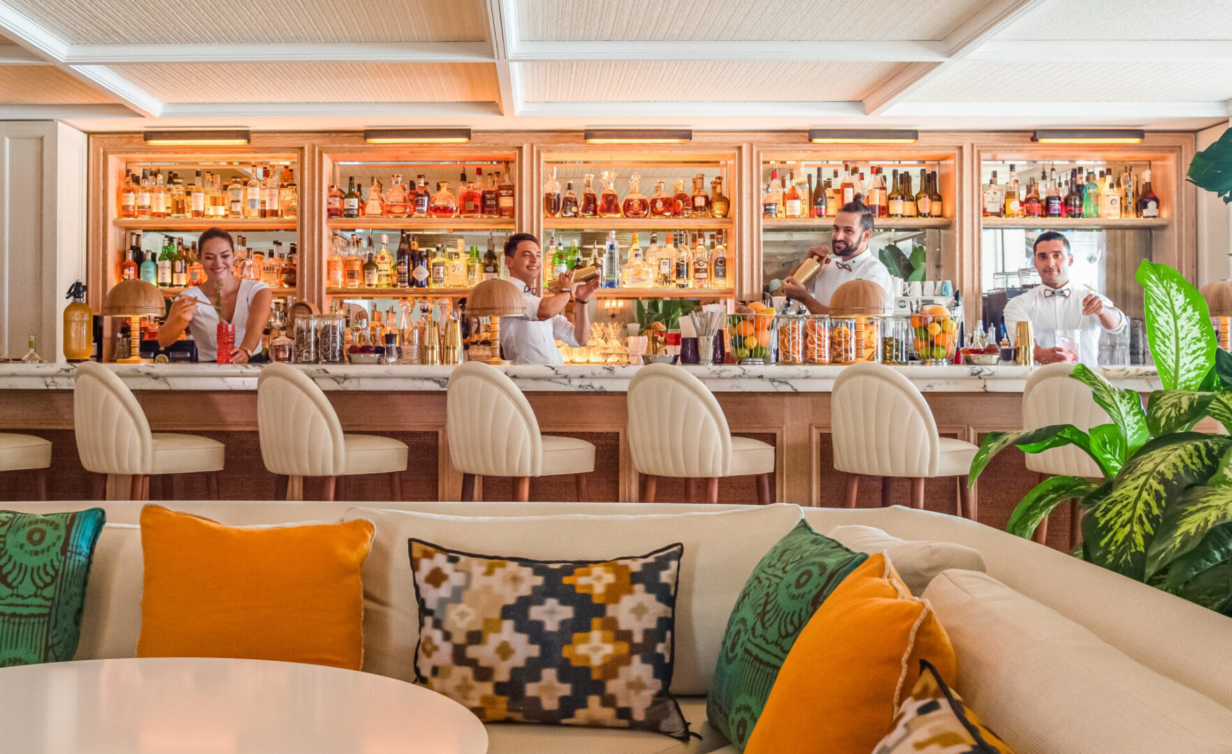 A bar with people sitting at the bar
