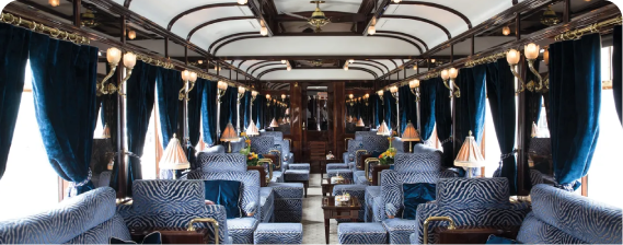 A train car with blue chairs and tables.