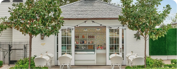 A white building with two chairs and a counter.